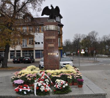 Pomnik Niepodległości udekorowany złożonymi wiązankami.