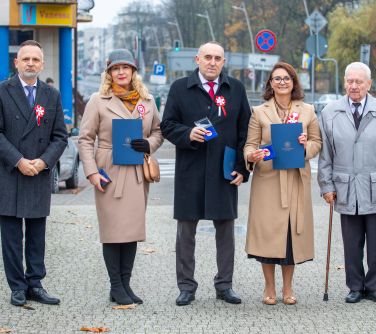 pięć osób pozuje do zdjęcia