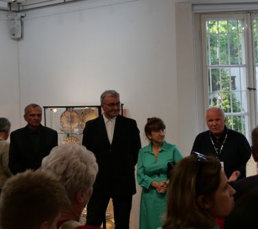 We wnętrzu budynku, zgromadzone osobysłuchają przemawiającego mężczyzny